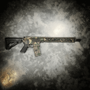 AMERICAN RESISTANCE AR15 RIFLE WITH 16" BARREL, HOGUE GRIP AND STOCK, AND M81 CAMO CERAKOTE.