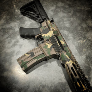 AMERICAN RESISTANCE AR15 RIFLE WITH 16" BARREL, HOGUE GRIP AND STOCK, AND M81 CAMO CERAKOTE.