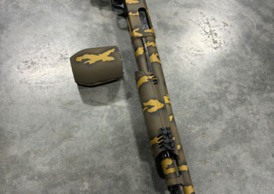 MOSSBERG 500 12 GAUGE SHOTGUN WITH CUSTOM TIGER STRIPE CERAKOTE FINISH.